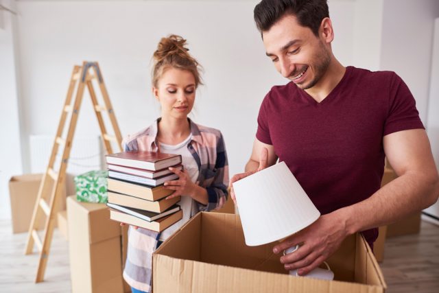 Couple packing books lamp boxes